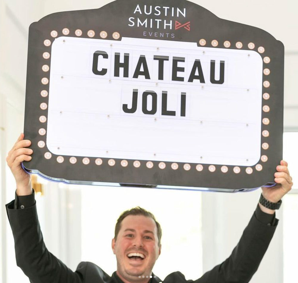 Wedding guest holding a Wedding Party Sign with a custom message.