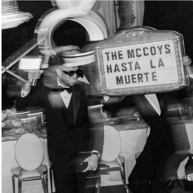 Wedding guest holding a Wedding Party Sign with a custom message.