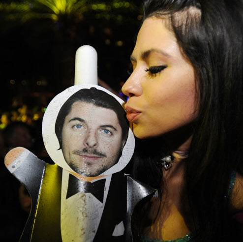 Wedding guest holding a engagement ring neon sign.